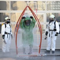 HAZWOPER worker in Level A ensemble in decontamination station