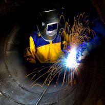 Worker wearing PPE welding