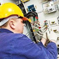 Electrical technician working on electrical panel 