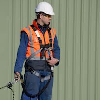 Worker wearing personal fall arrest system